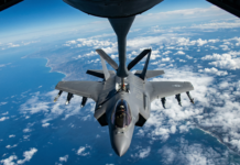 An F-35 Lighting II stealth jet refuels in mid air.