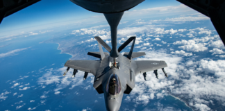 An F-35 Lighting II stealth jet refuels in mid air.