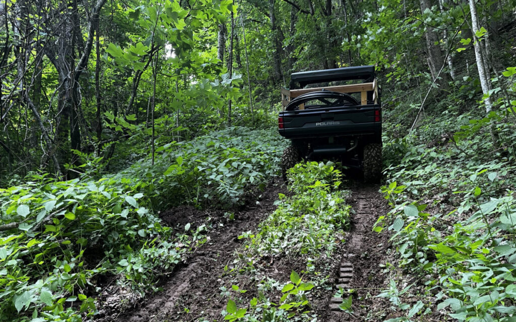 The Polaris Ranger heading up the mountain to deliver pipe and other supplies to the springhead.