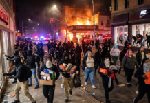A protest turns violent and looting breaks out after darkness falls.