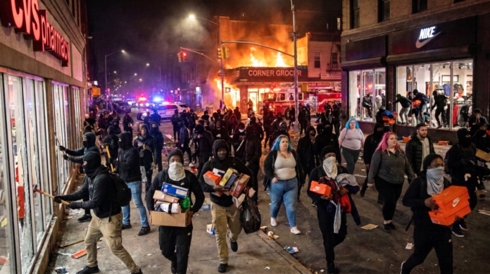 A protest turns violent and looting breaks out after darkness falls.