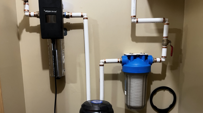 The water flow through the particulate filter on the right, into the charcoal filter (barely seen on the bottom) and then through the UV light for final purification.